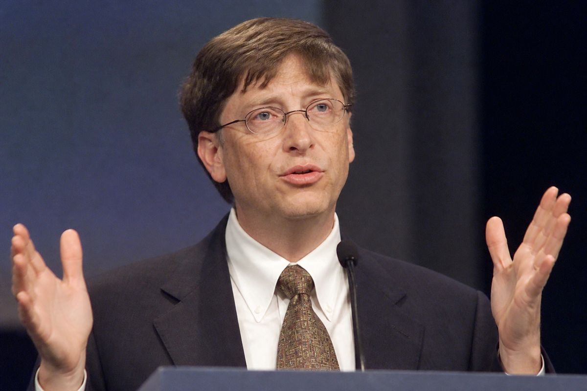 Bill Gates speaking at a technology conference podium