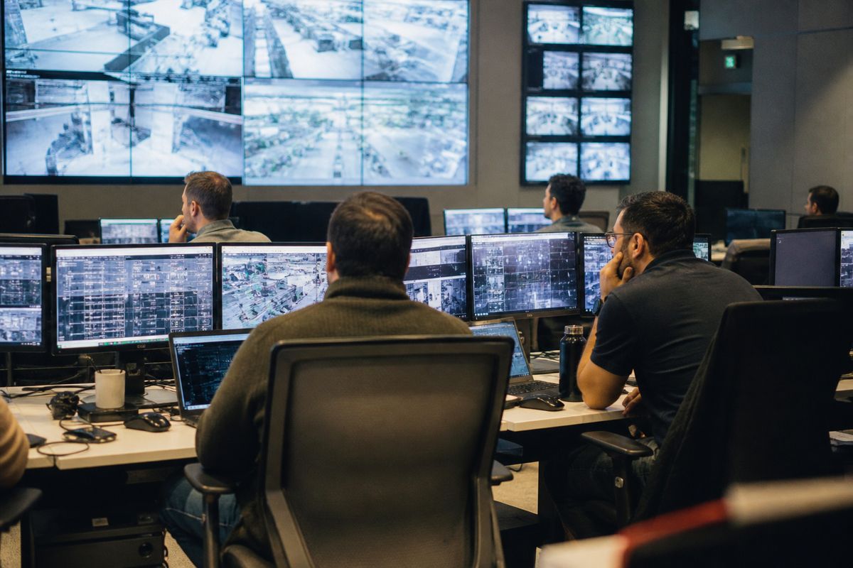 Engineers monitoring AI systems in a modern control room
