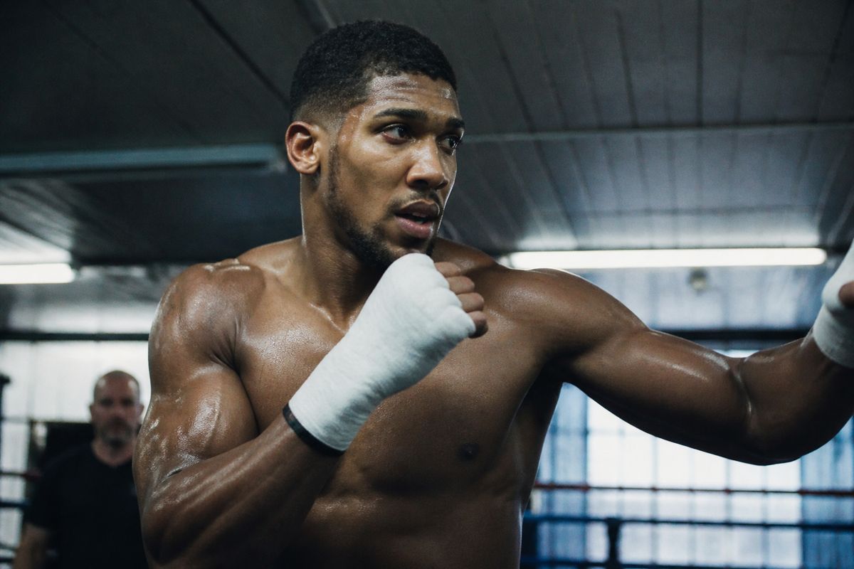 Anthony Joshua training intensely in a boxing gym