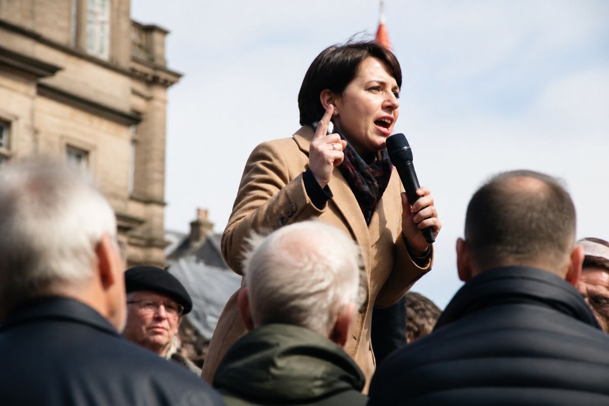 A candidate speaking passionately at a local by-election rally