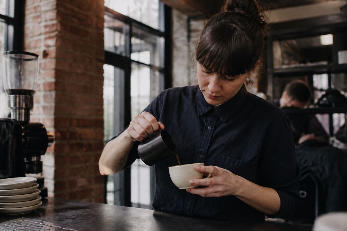 Barista carefully pouring espresso at Square Mile Coffee Roasters