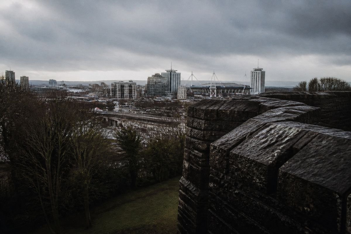A cloudy sky over Cardiff cityscape with light rain.