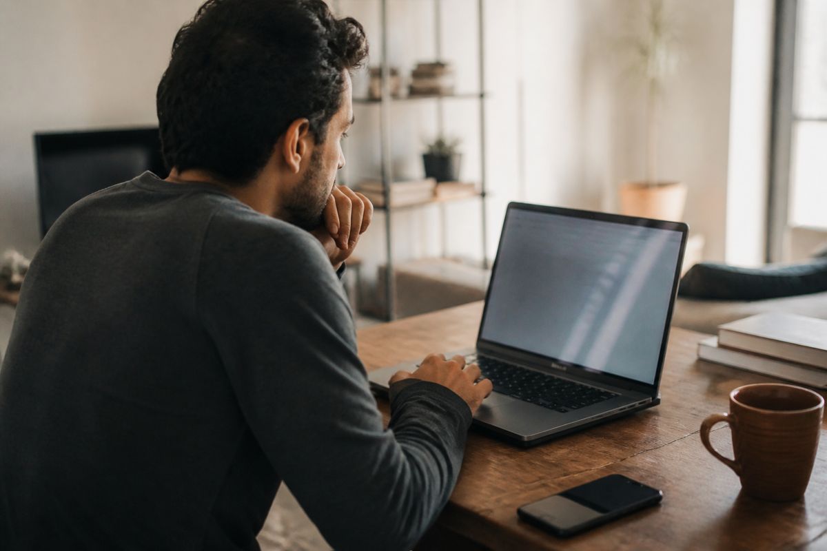 A person checking their driver’s license status on a laptop at home