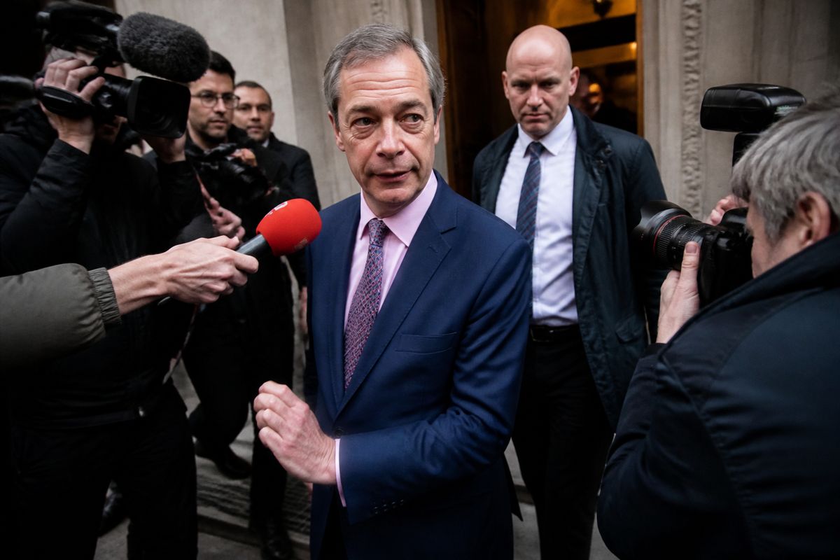 Nigel Farage leaving a building surrounded by reporters