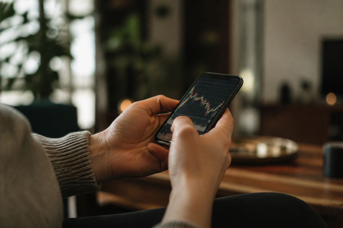 A person using a smartphone app to trade cryptocurrency