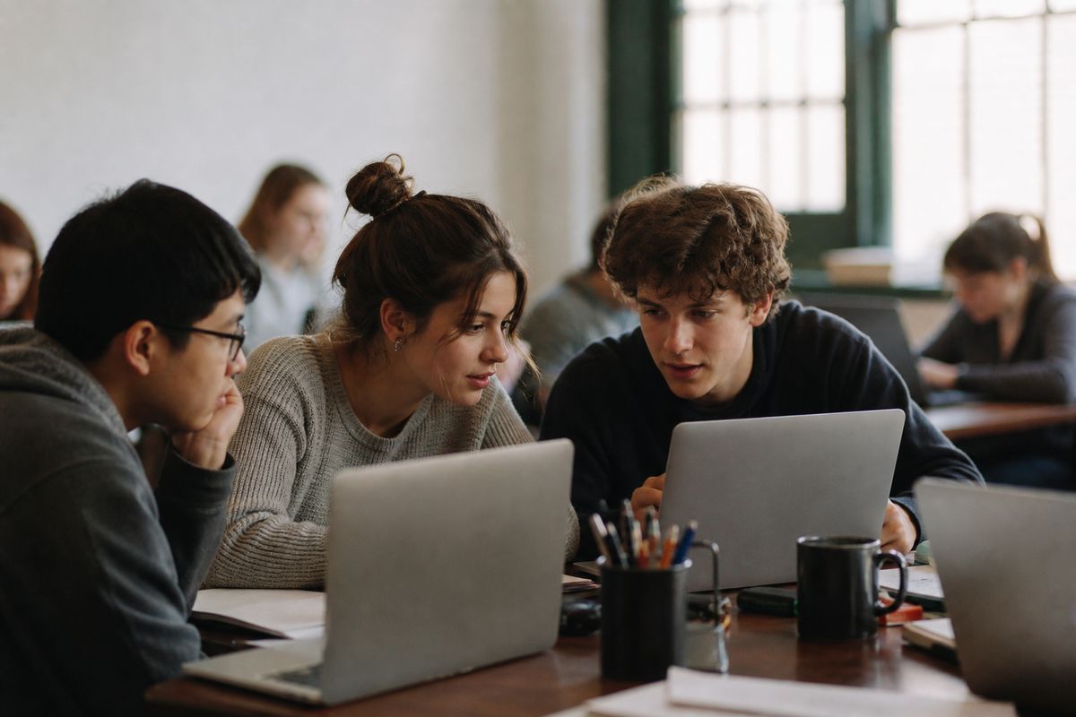 Students collaborating on data science projects in a classroom