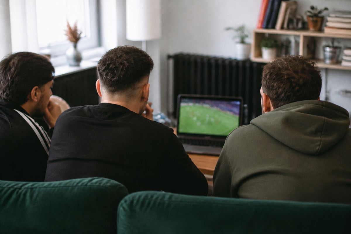 Fans watching a live football match on a laptop screen