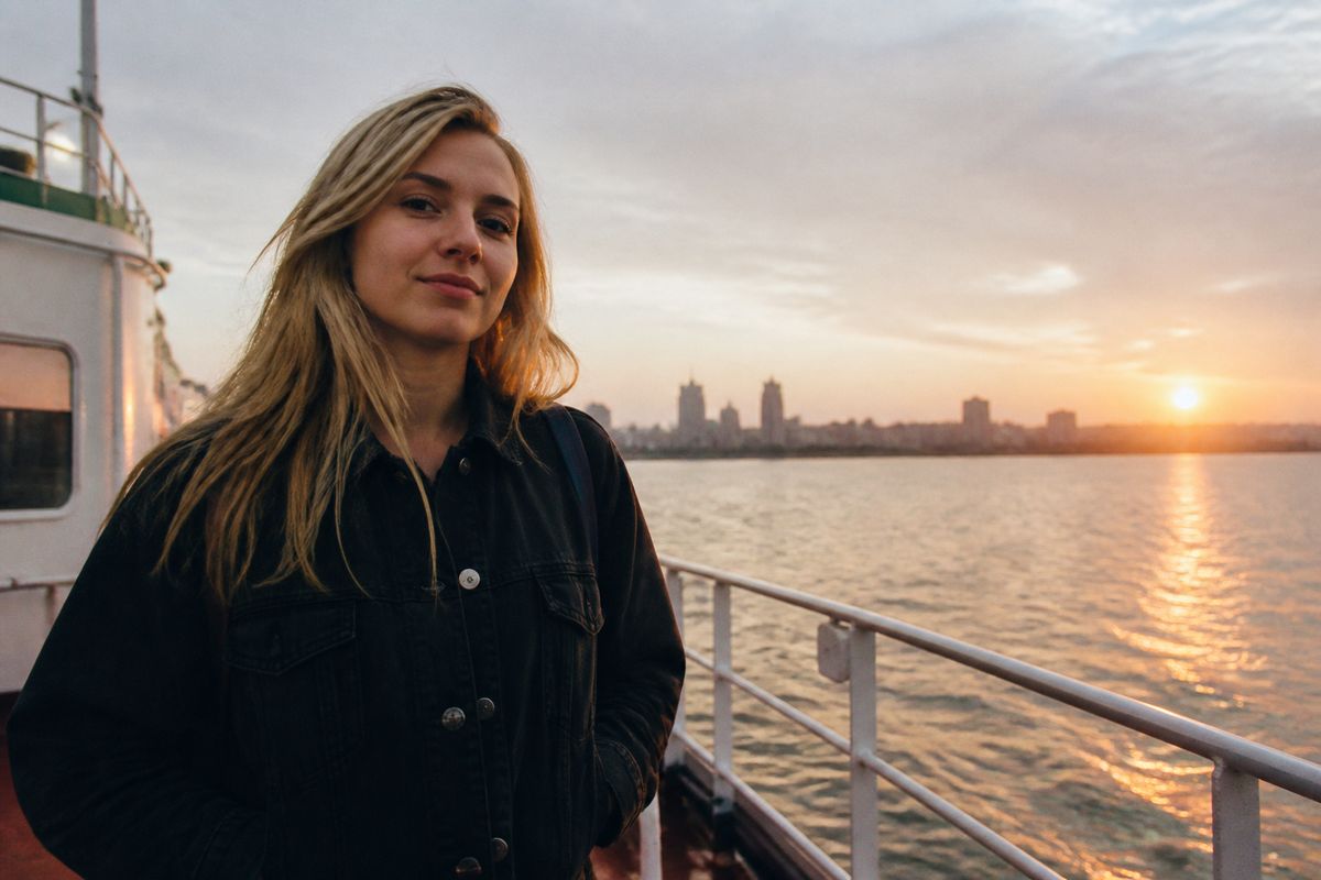 Ellie standing confidently on the Mersey Ferry deck at sunrise