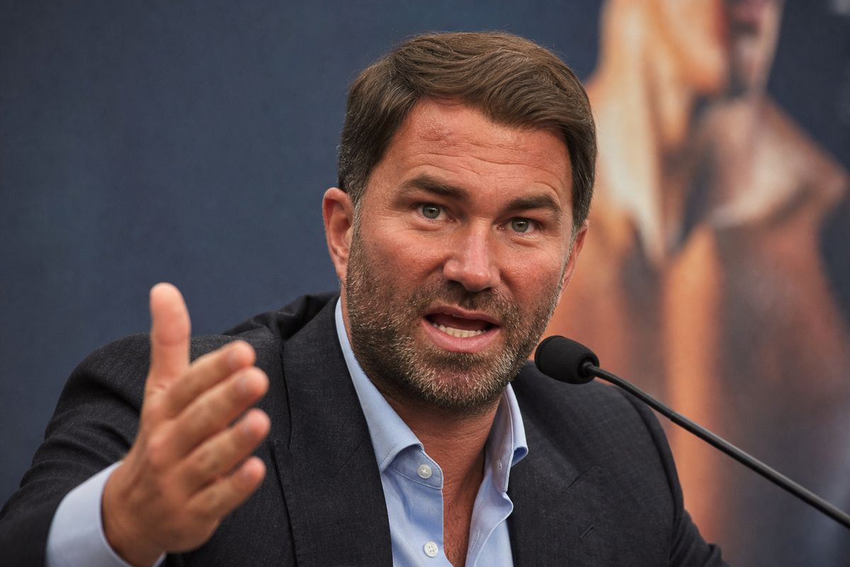 Eddie Hearn speaking passionately at a boxing press conference.