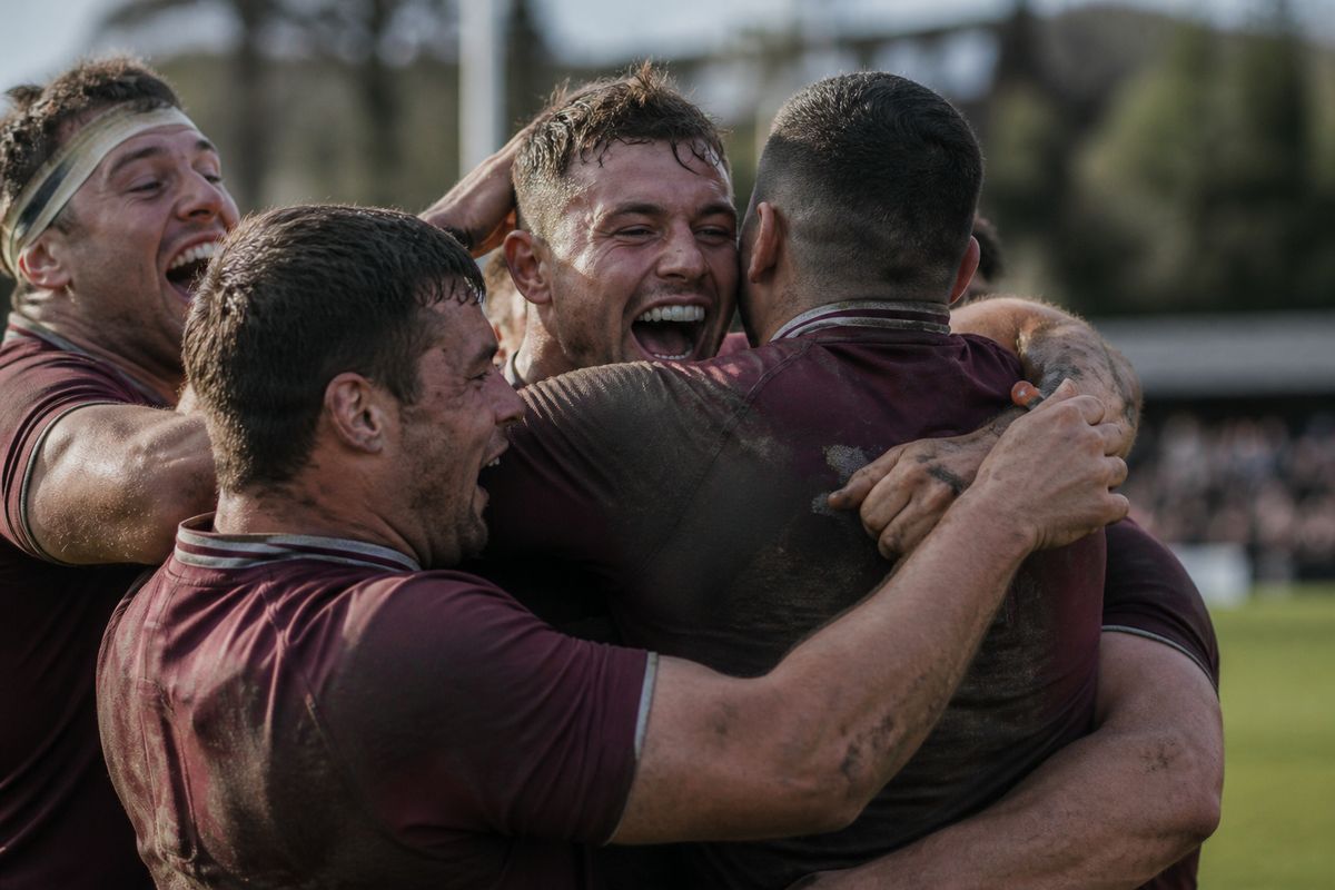 Rugby players celebrating a hard-fought victory on the pitch
