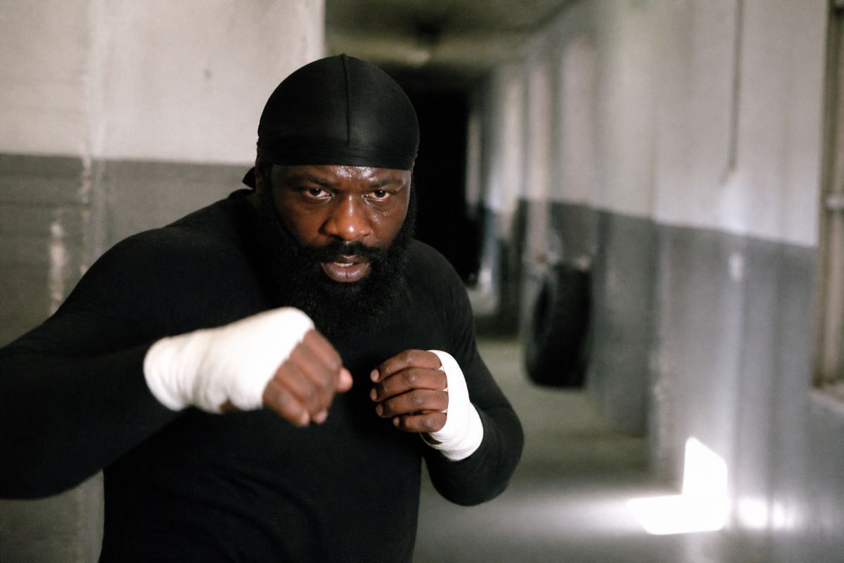 Kimbo Slice training in a gritty urban gym hallway.