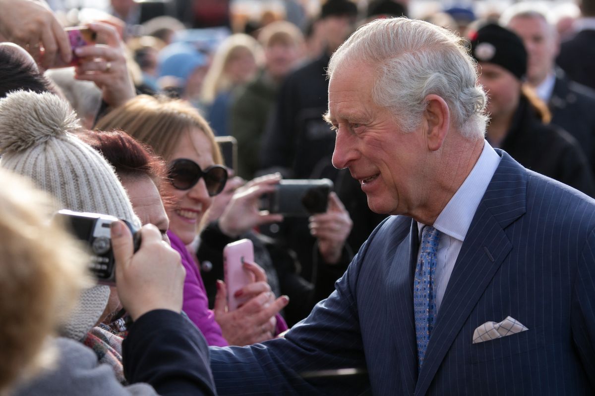 King Charles greeting crowds during a public event outdoors