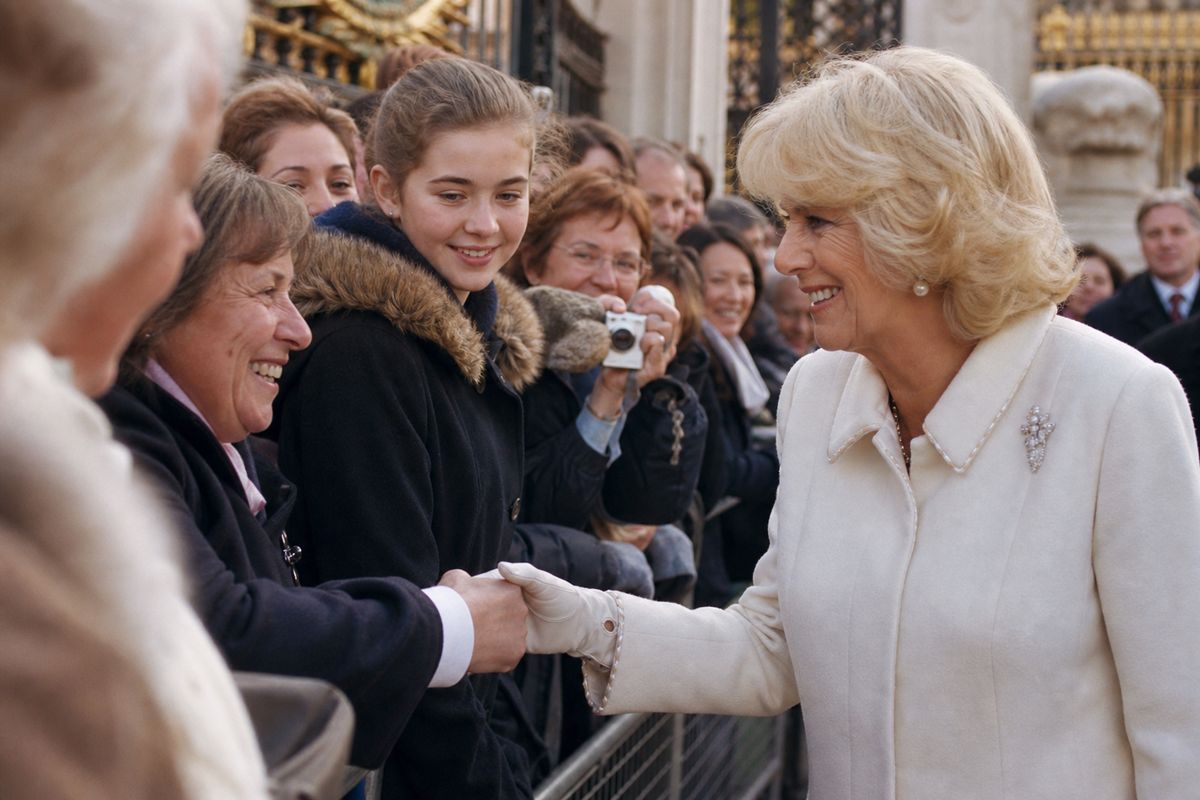 Queen Camilla greeting visitors at Buckingham Palace gates