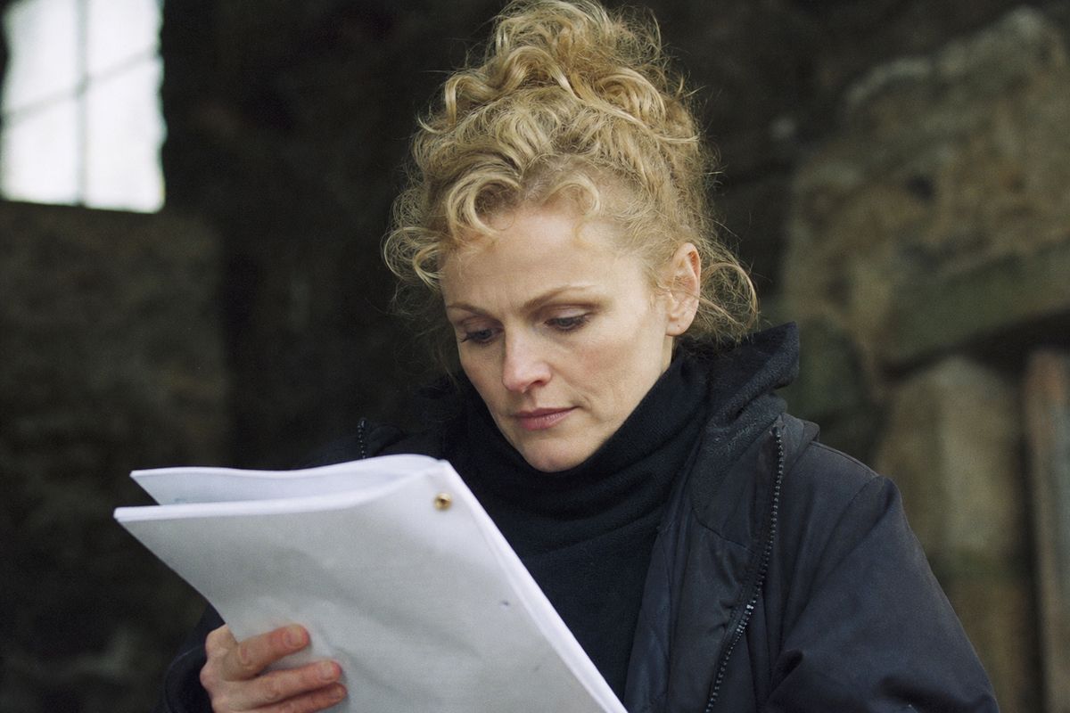 Maxine Peake on set, intently reviewing a script
