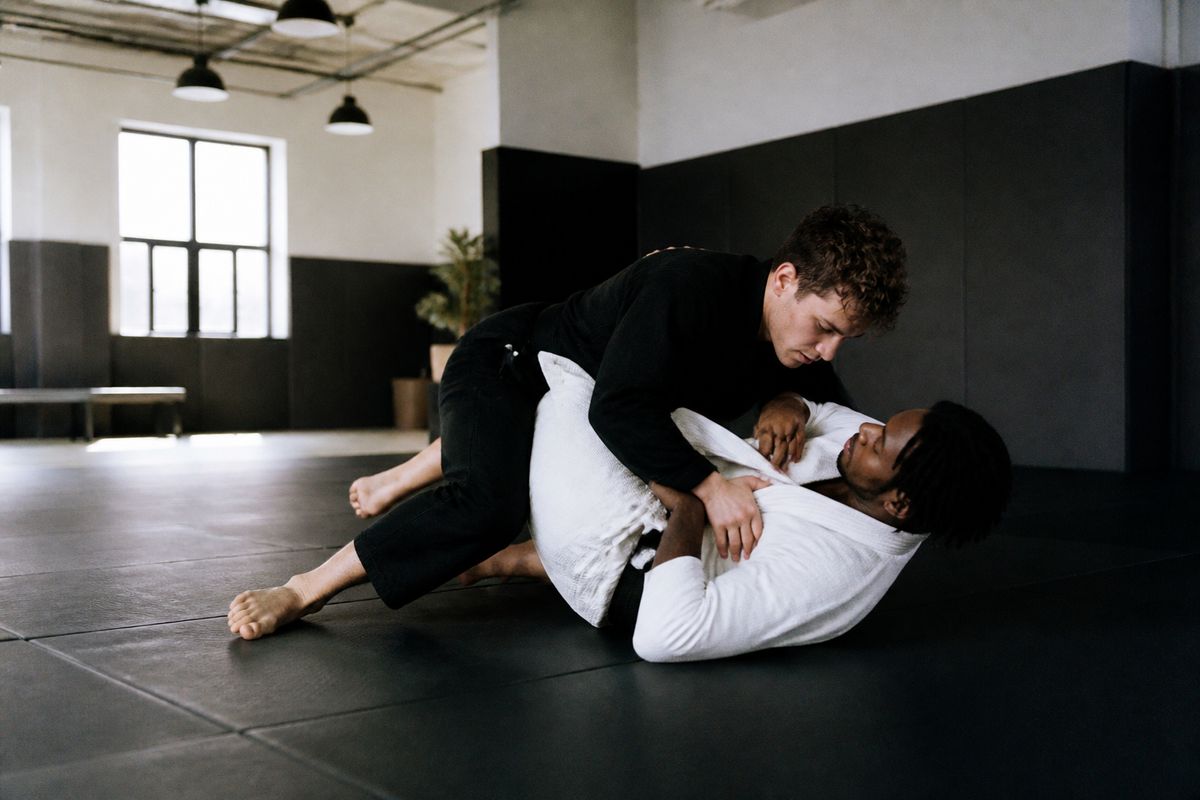 A clean, modern martial arts gym with padded mats