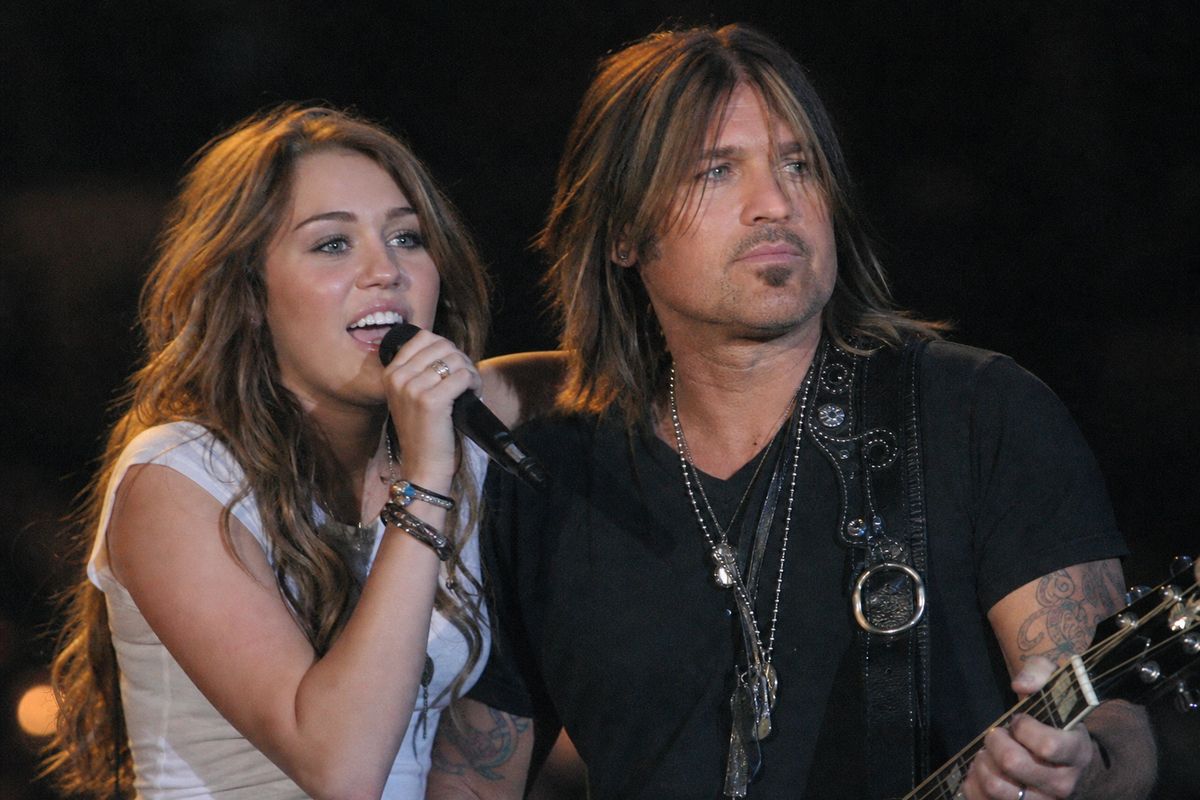 Miley Cyrus and Billy Ray Cyrus performing together on stage