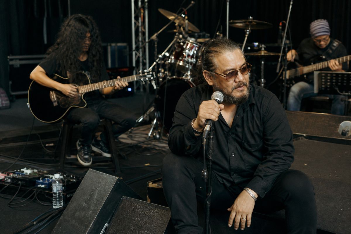 Dato’ Awie rehearsing on stage with band in Singapore venue