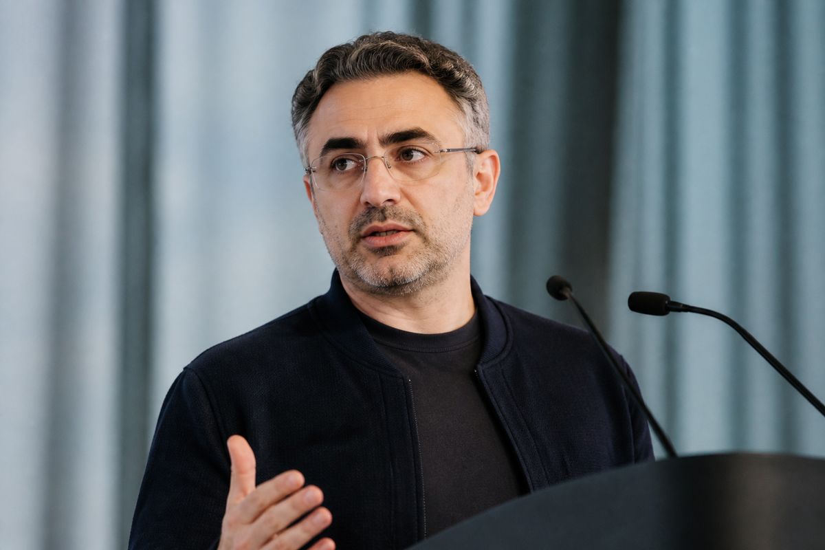 Mustafa Suleyman speaking at a technology conference podium