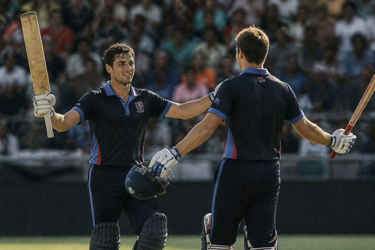 Namibian cricket batsmen celebrating a crucial partnership.