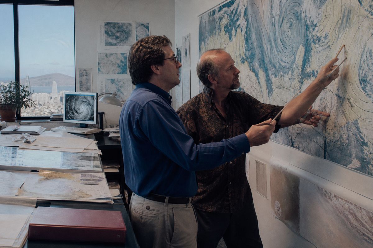 Meteorologists analyzing weather maps in a San Francisco newsroom