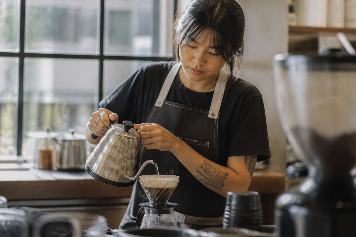 Barista preparing a specialty coffee at Coffee Goblin cafe