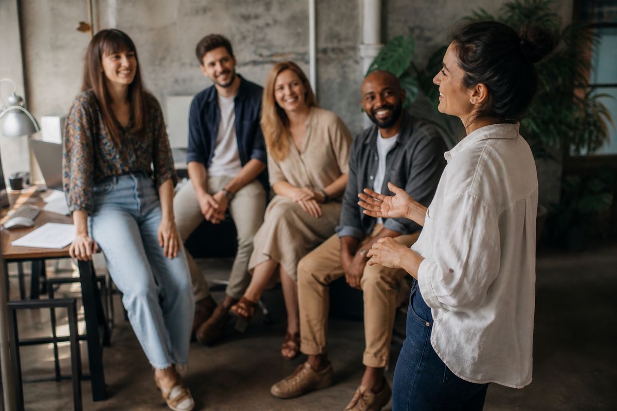 A small business owner introducing their team in a cozy office.