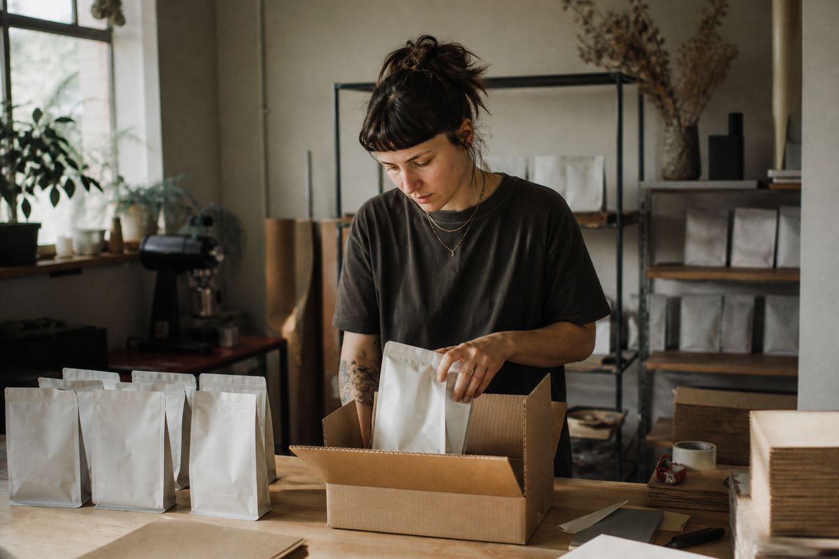 A barista packing specialty coffee bags for shipment