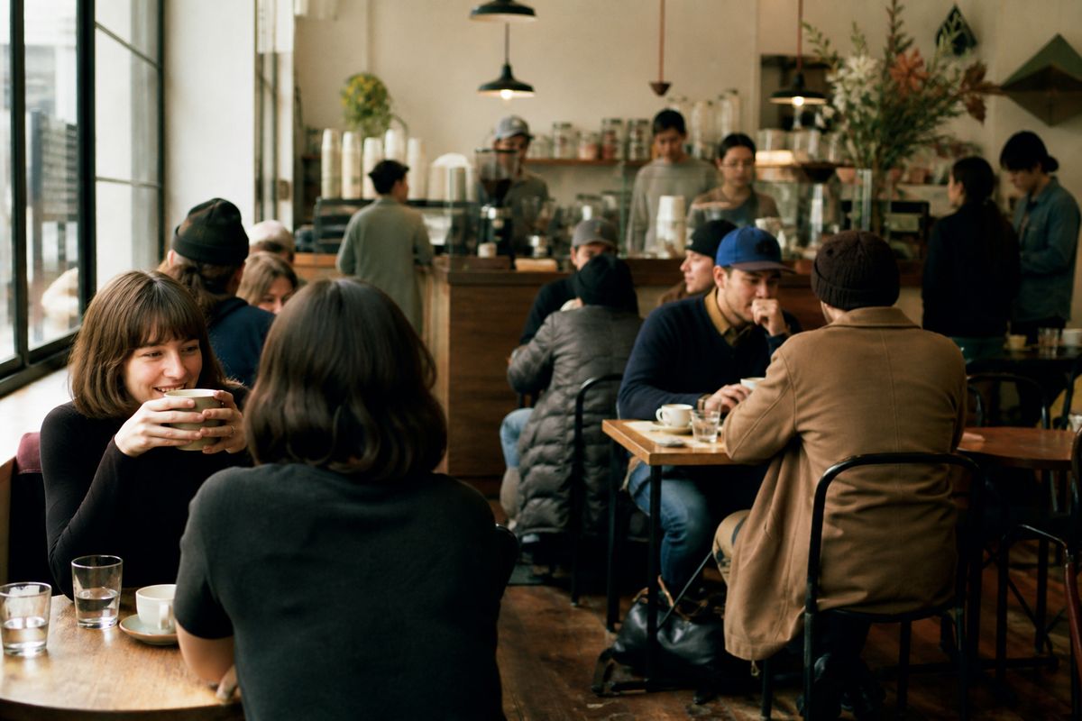 Patrons enjoying coffee at a bustling specialty café.