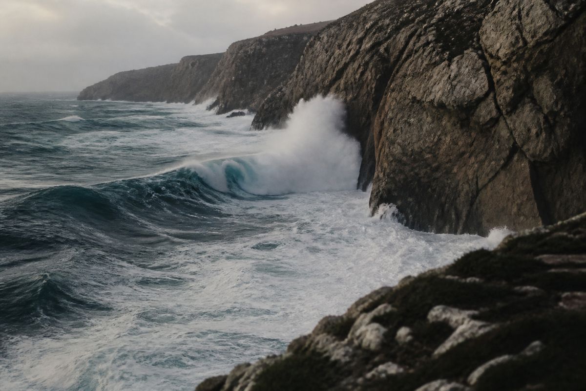 Massive waves crashing against eroding coastal cliffs