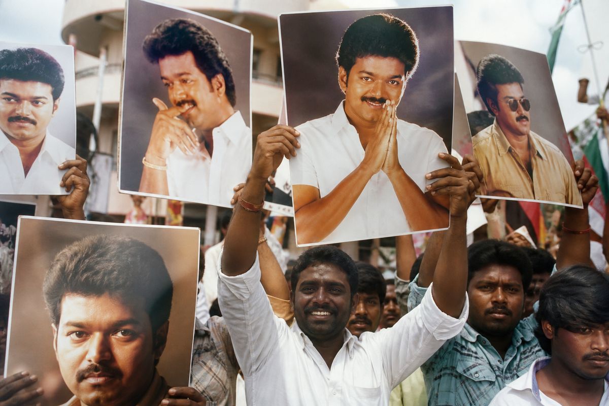 Supporters rallying with posters of a Tamil film star politician