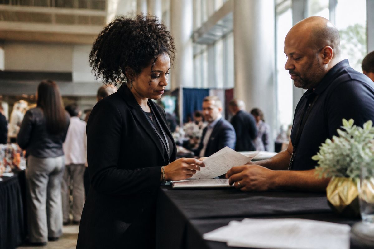 Event organizer coordinating with vendor at conference venue