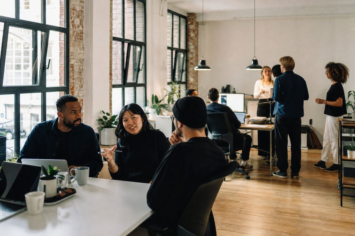 A bustling London tech office with diverse startup teams collaborating.