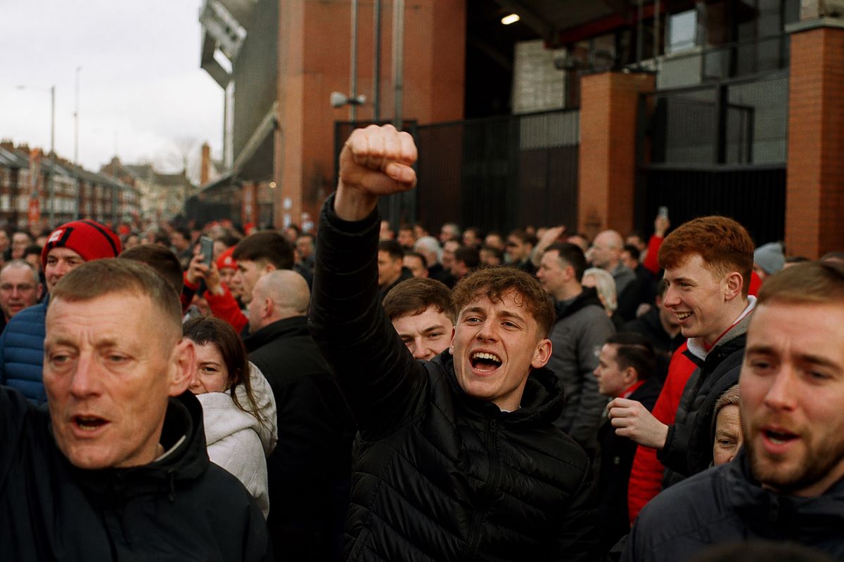 Fans celebrating outside Anfield Stadium on match day