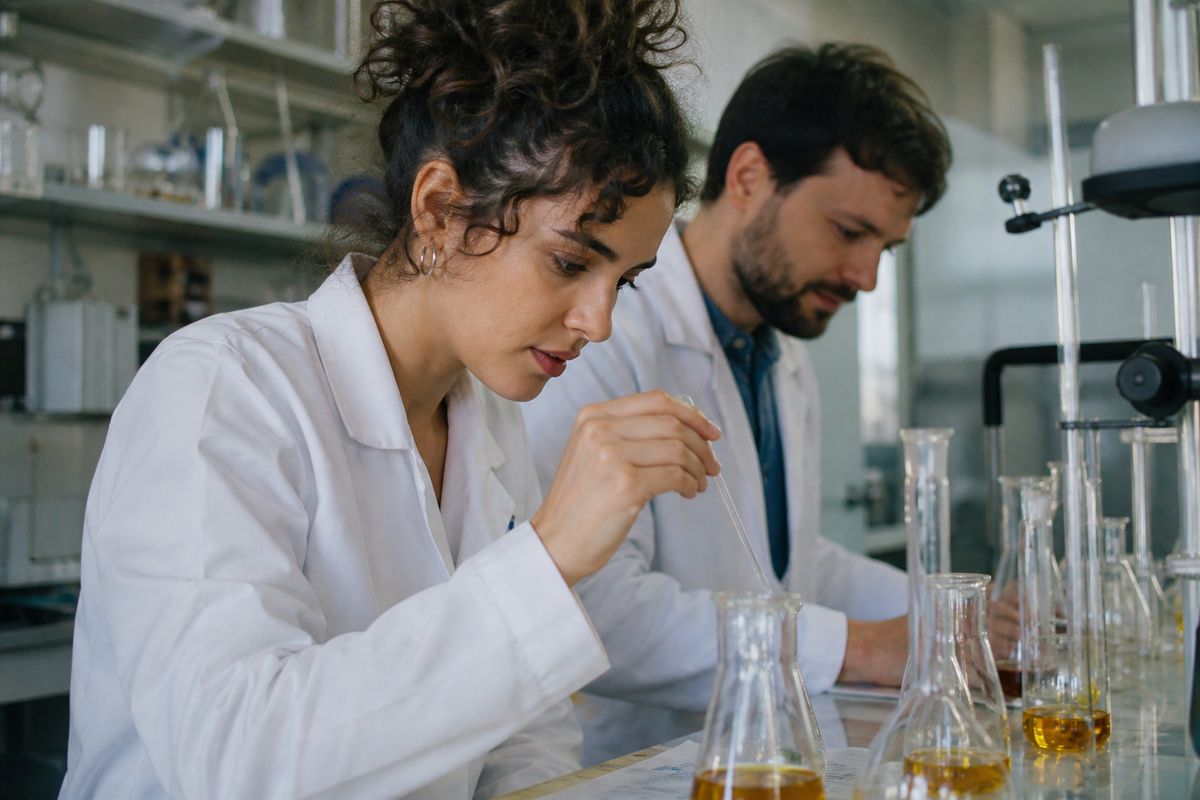 Scientists examining chemical compounds in a laboratory setting