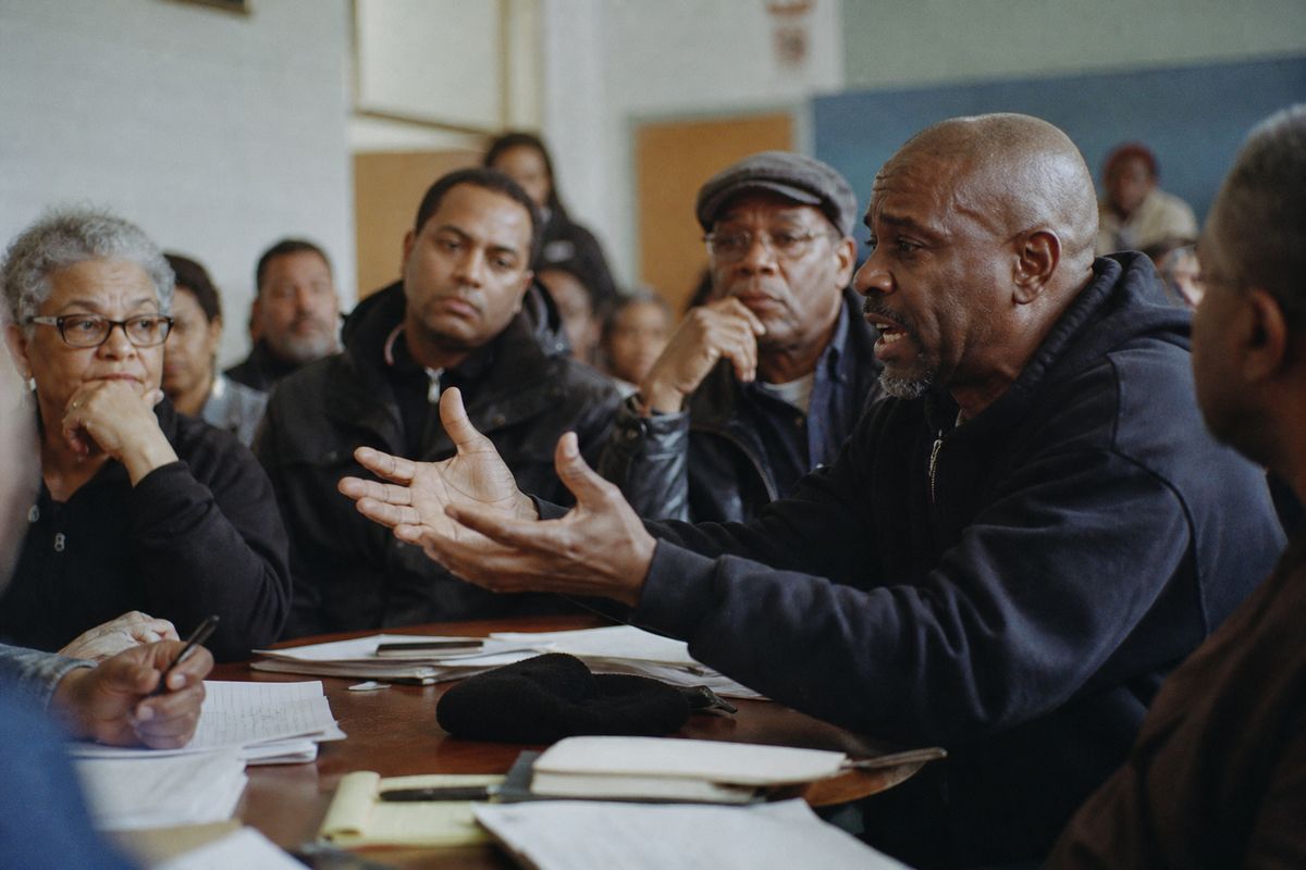 People debating in a community meeting room