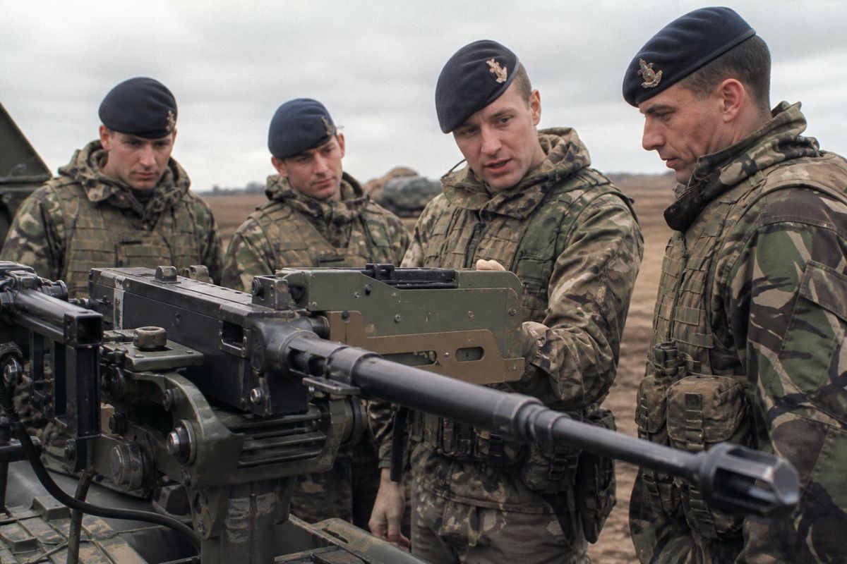 British soldiers inspecting new military equipment outdoors
